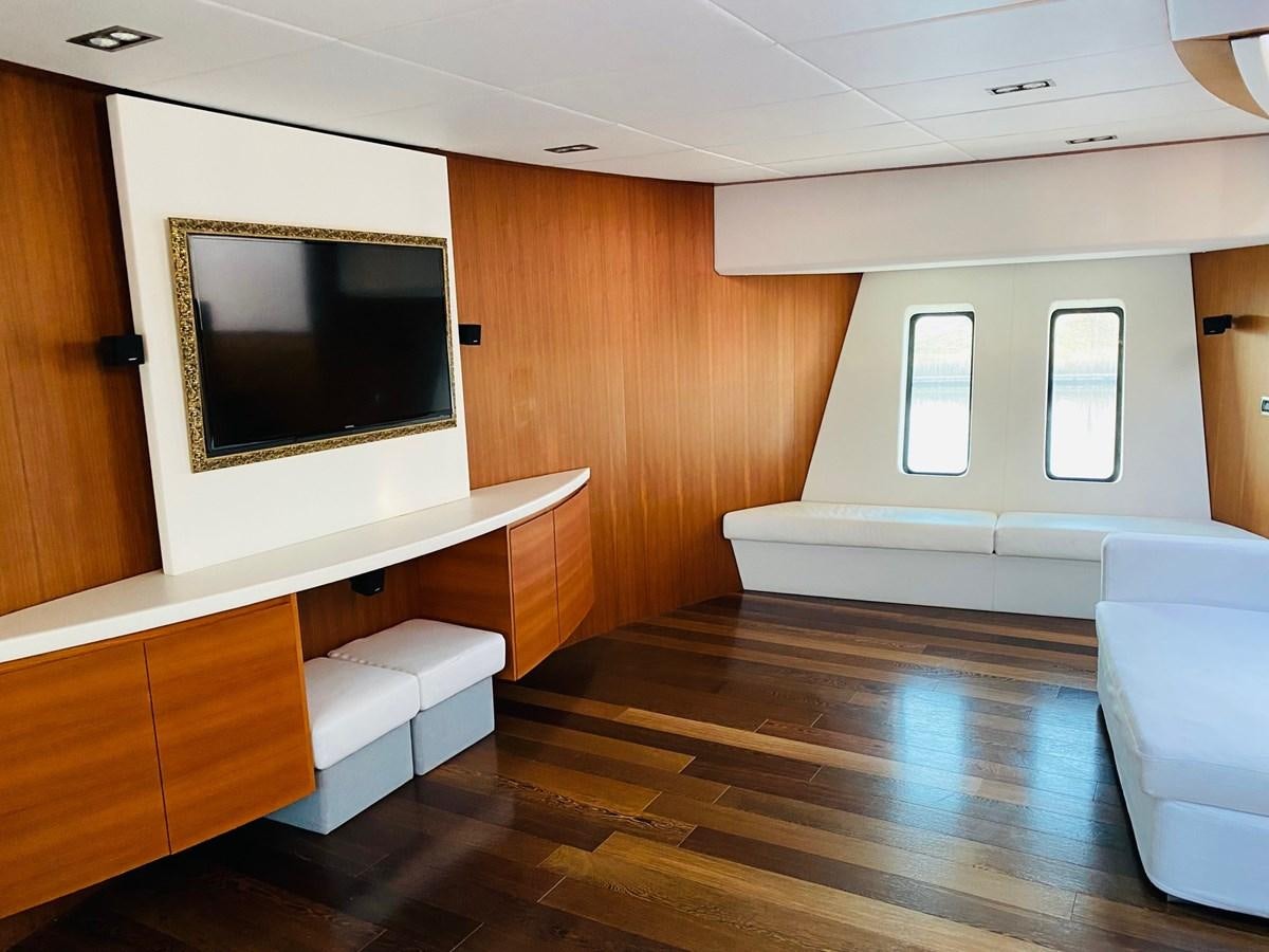 a room with a tv and a couch aboard GINEVRA Yacht for Sale