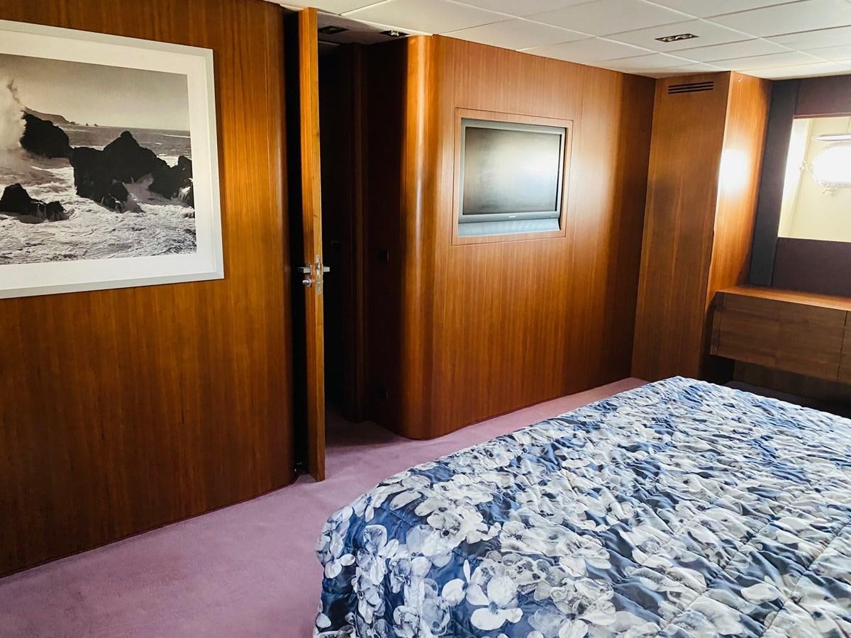 a room with a bed and a television aboard GINEVRA Yacht for Sale