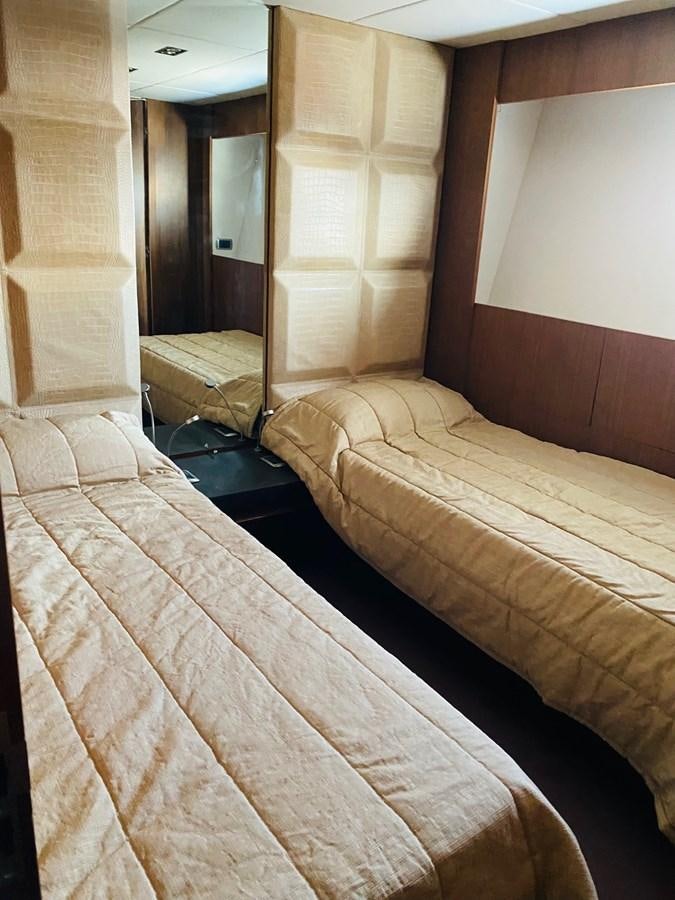 a room with a bed and a wood door aboard GINEVRA Yacht for Sale
