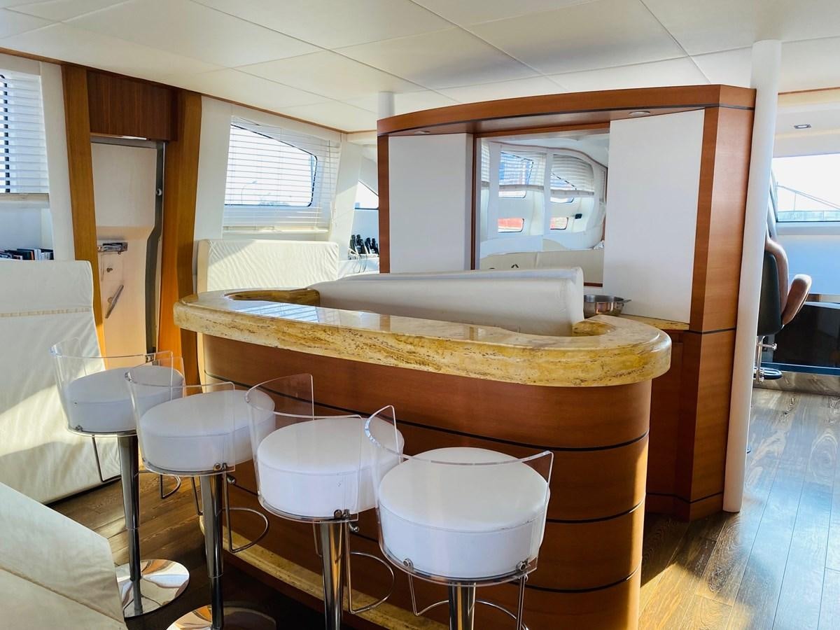 a room with stools and a table aboard GINEVRA Yacht for Sale