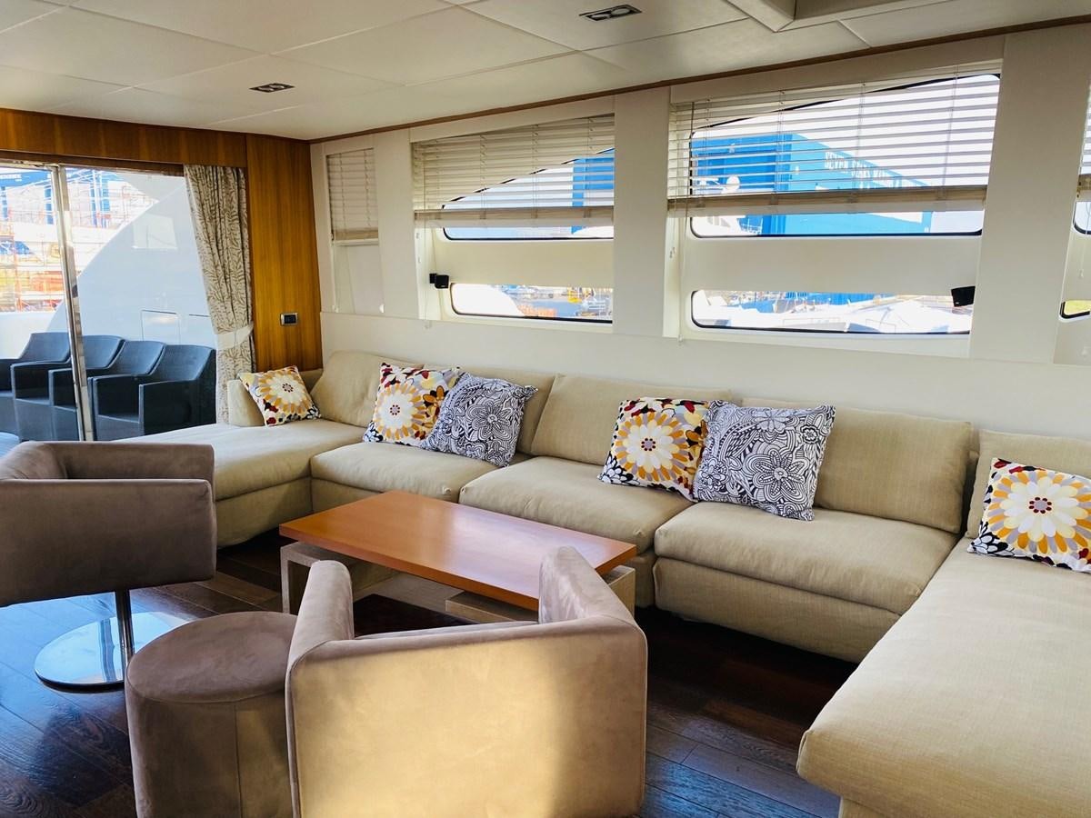 a living room with a couch and a table aboard GINEVRA Yacht for Sale