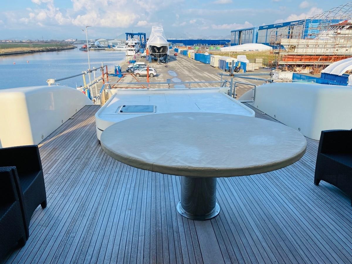 a table on a deck overlooking a body of water aboard GINEVRA Yacht for Sale