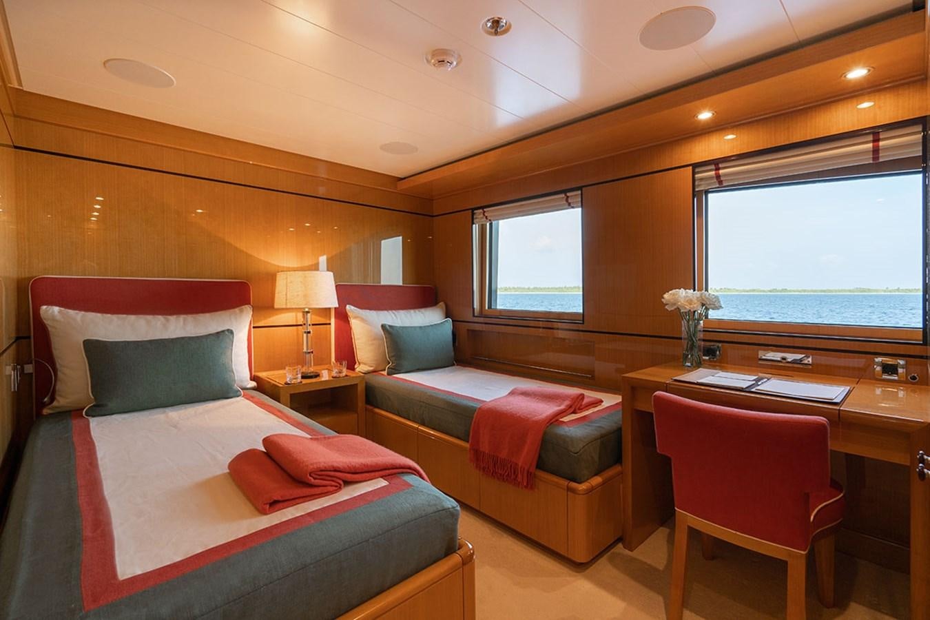 a room with a bed and a desk aboard DEEP BLUE Yacht for Sale