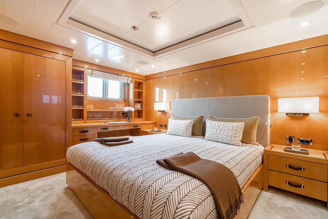 a bedroom with a bed and a desk aboard DEEP BLUE Yacht for Sale