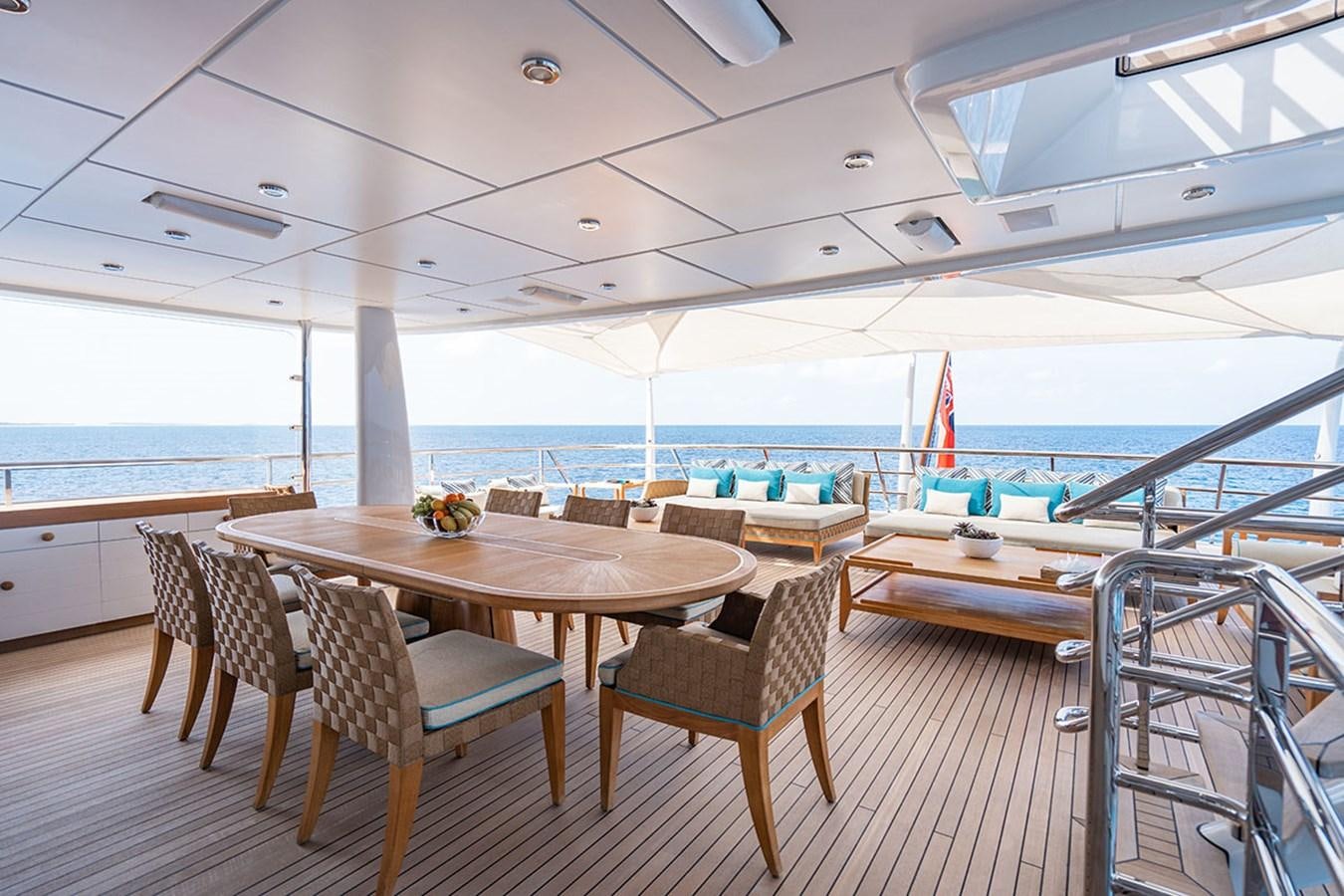 a table and chairs on a deck aboard DEEP BLUE Yacht for Sale