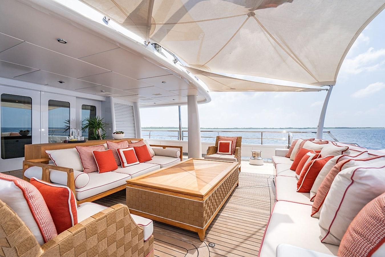 a living room with a large balcony aboard DEEP BLUE Yacht for Sale