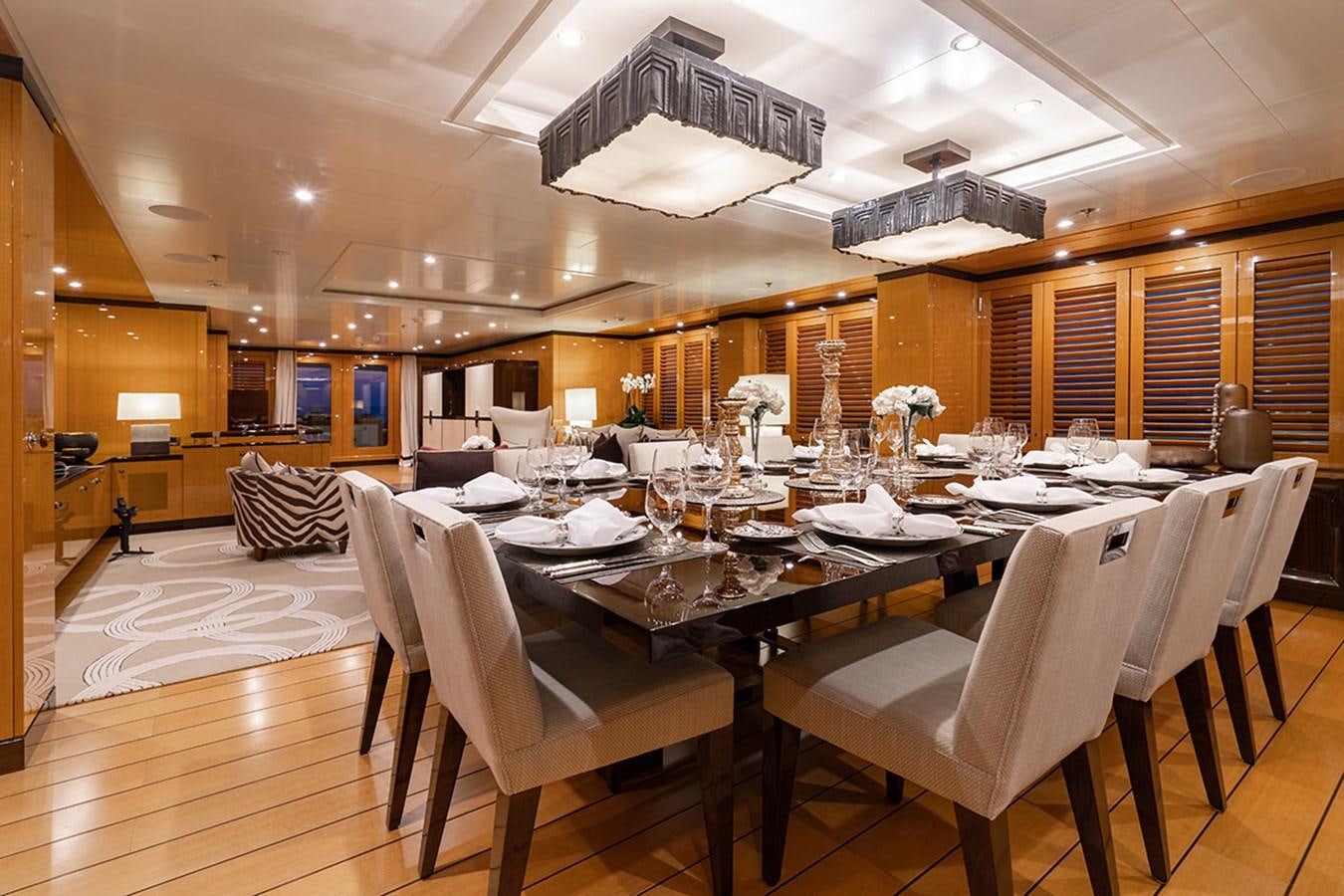 a dining room with a table and chairs aboard DEEP BLUE Yacht for Sale