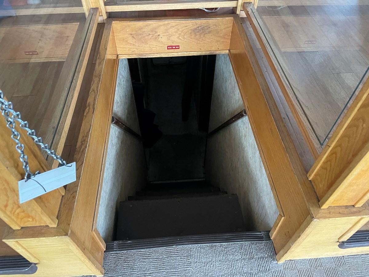 a wooden cabinet with a black door aboard MAGIC MOMENT Yacht for Sale