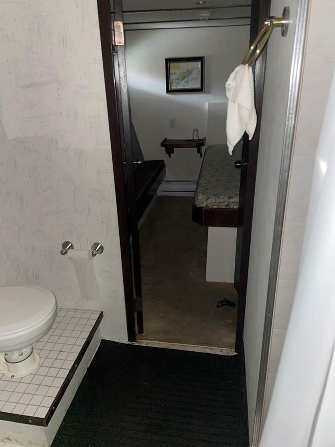 a bathroom with a toilet and a sink aboard MAGIC MOMENT Yacht for Sale