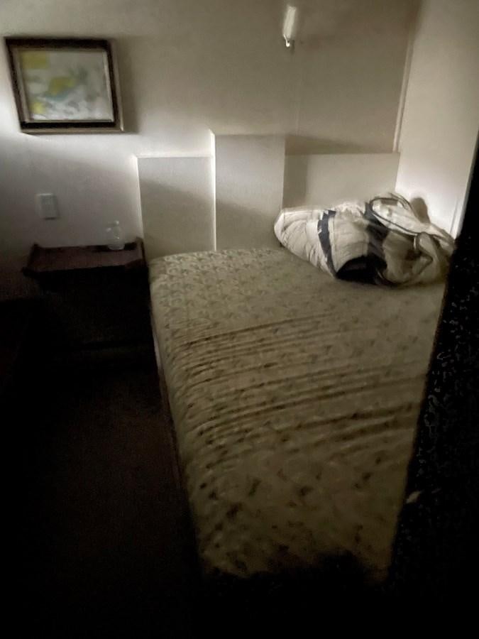 a bed with a blanket on it aboard MAGIC MOMENT Yacht for Sale