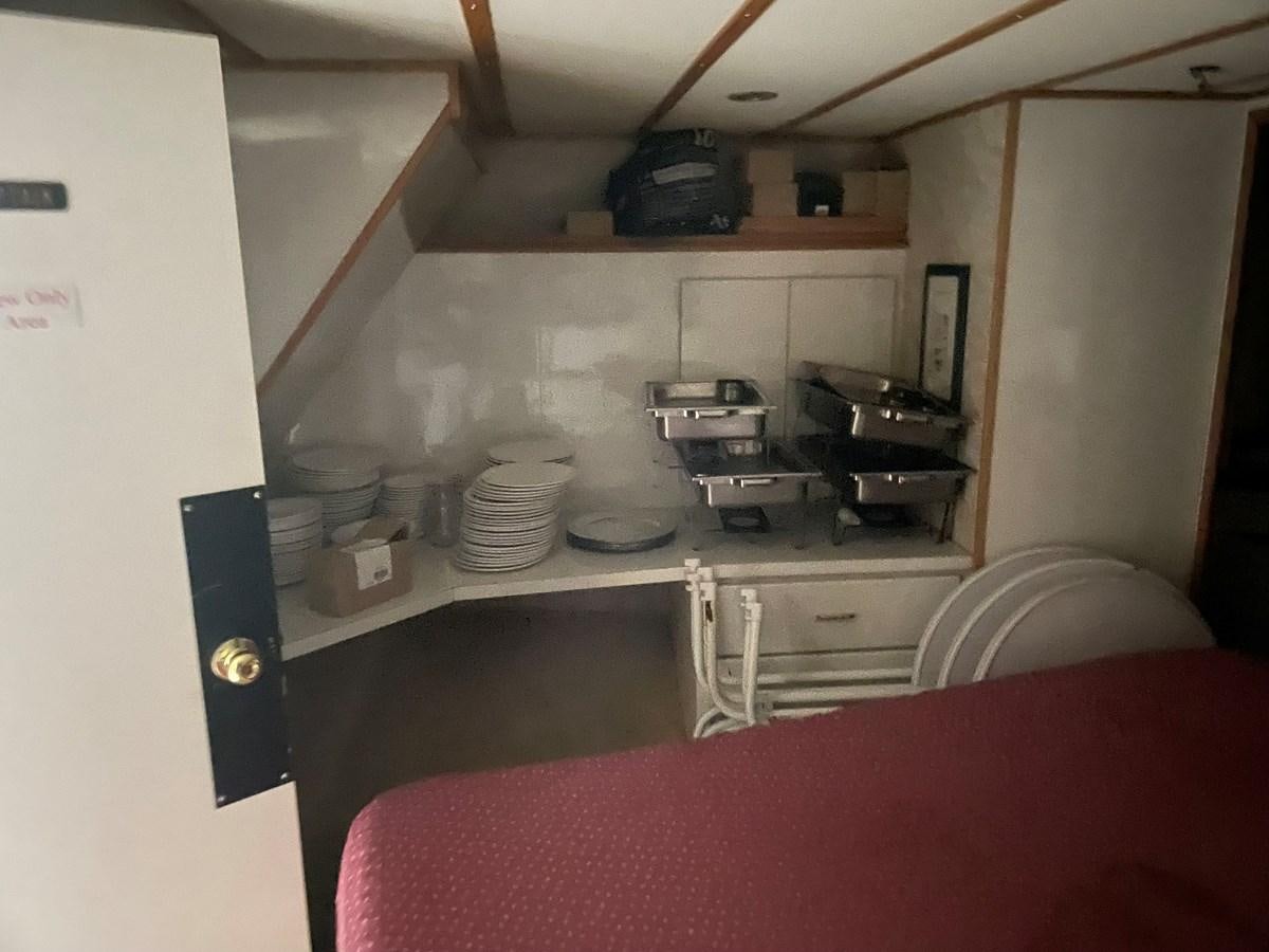 a kitchen with a red table cloth aboard MAGIC MOMENT Yacht for Sale