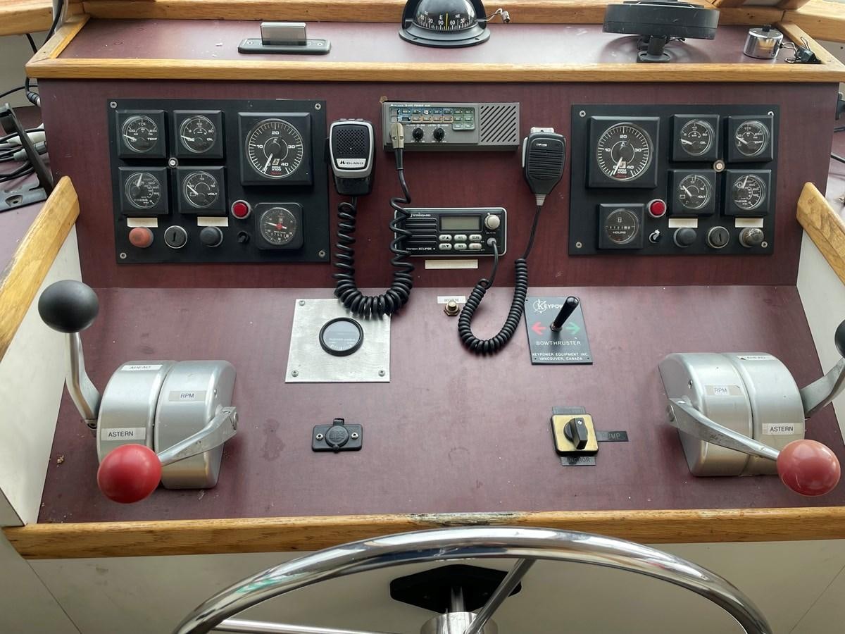 a wooden table with a small radio and other electronics on it aboard MAGIC MOMENT Yacht for Sale