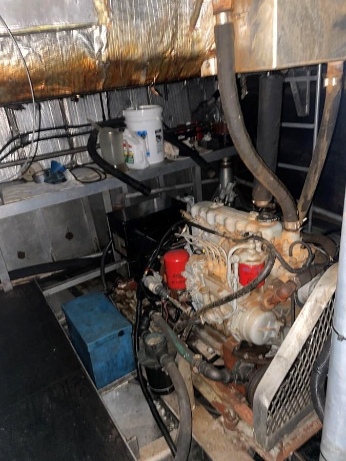 a room with a machine and pipes aboard MAGIC MOMENT Yacht for Sale