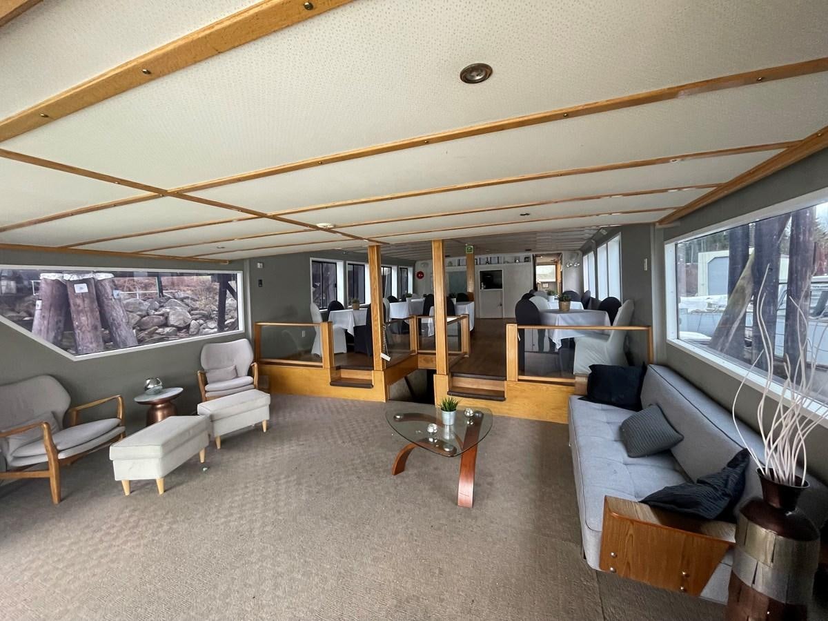 a living room with a large window aboard MAGIC MOMENT Yacht for Sale