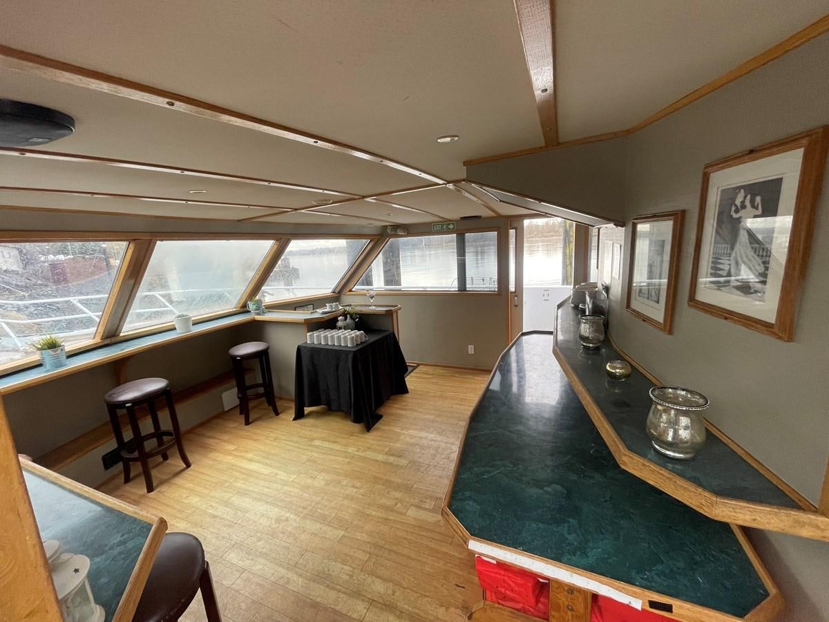 a large room with a pool table and chairs aboard MAGIC MOMENT Yacht for Sale
