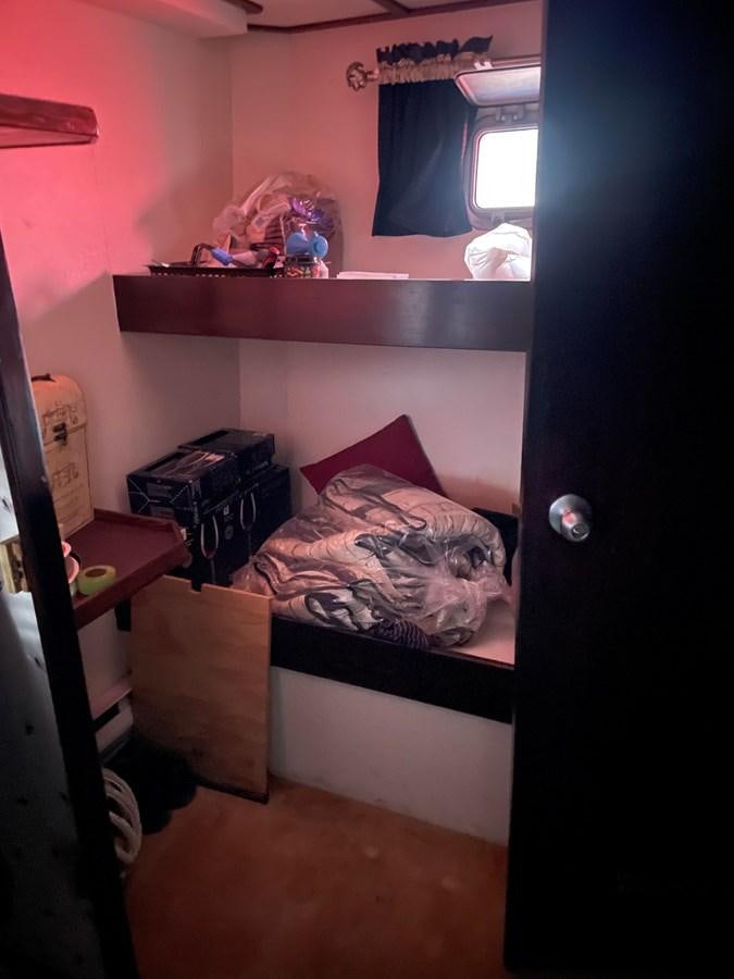 a small bedroom with a bed aboard MAGIC MOMENT Yacht for Sale