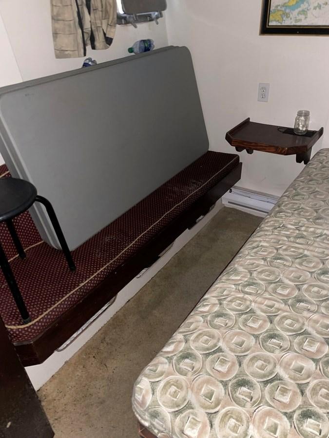 a bed with a black frame aboard MAGIC MOMENT Yacht for Sale