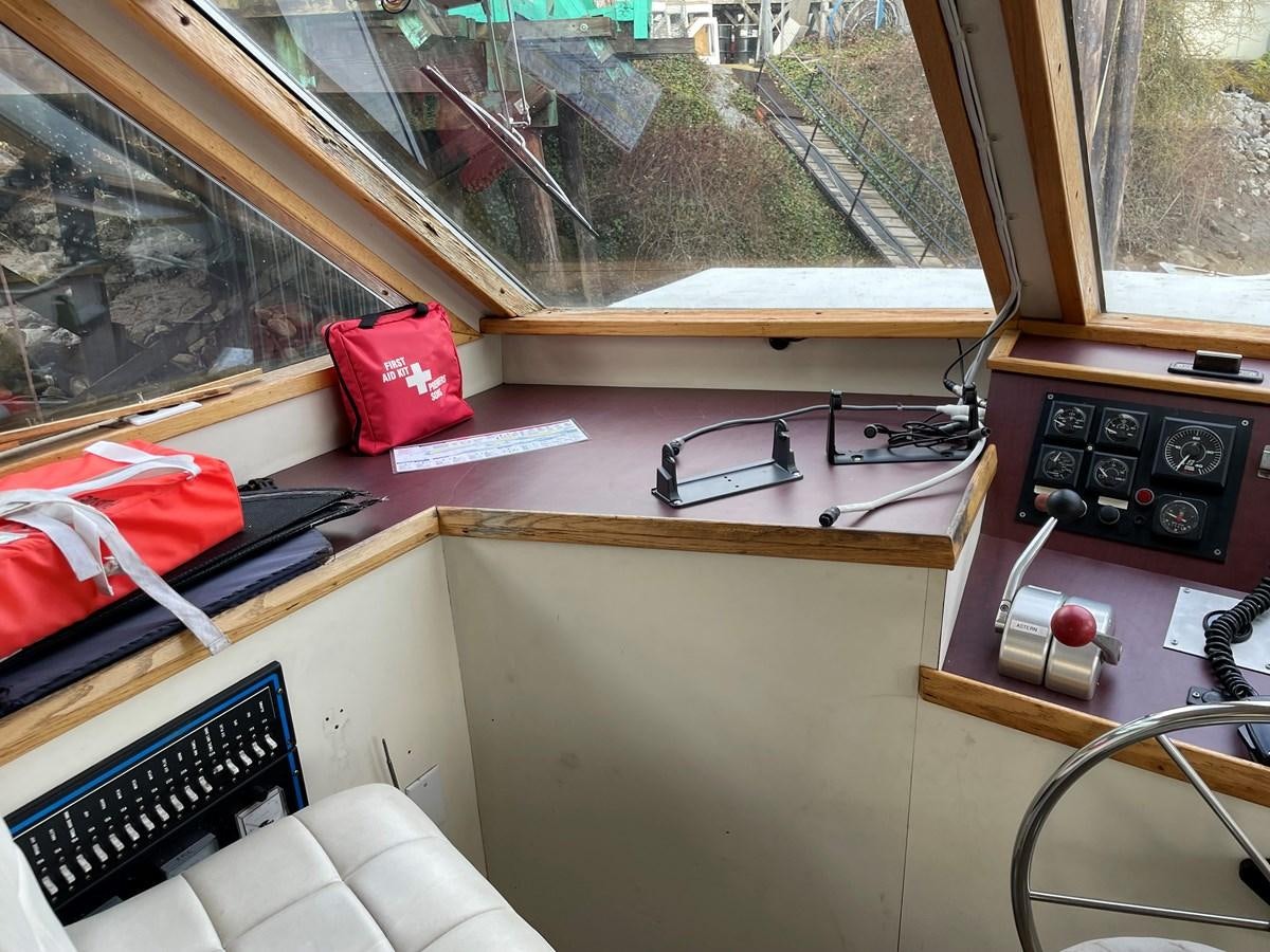 a desk with a phone and a window aboard MAGIC MOMENT Yacht for Sale