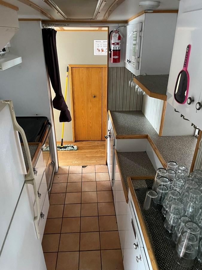 a kitchen with a tile floor aboard MAGIC MOMENT Yacht for Sale