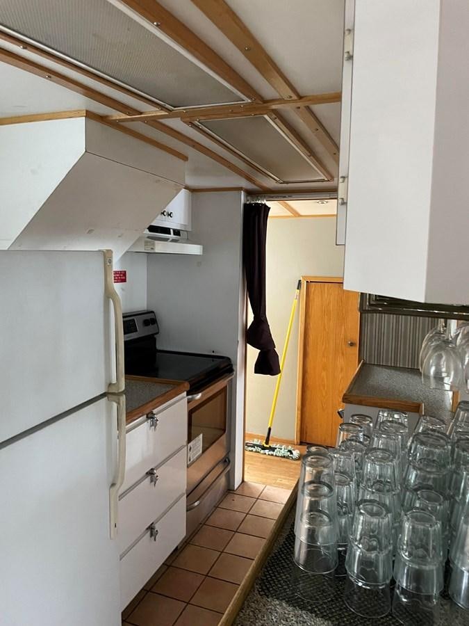 a kitchen with a lot of empty glasses on the floor aboard MAGIC MOMENT Yacht for Sale