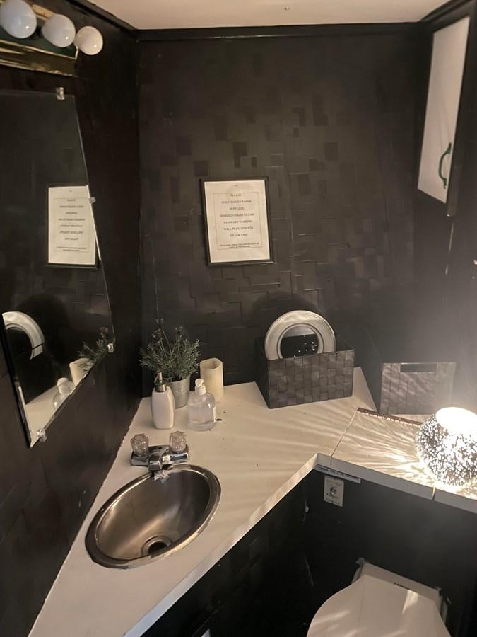a bathroom with a sink and mirror aboard MAGIC MOMENT Yacht for Sale