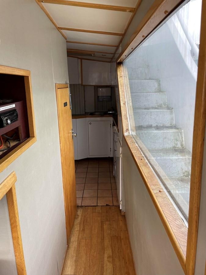 a kitchen with a stone wall aboard MAGIC MOMENT Yacht for Sale