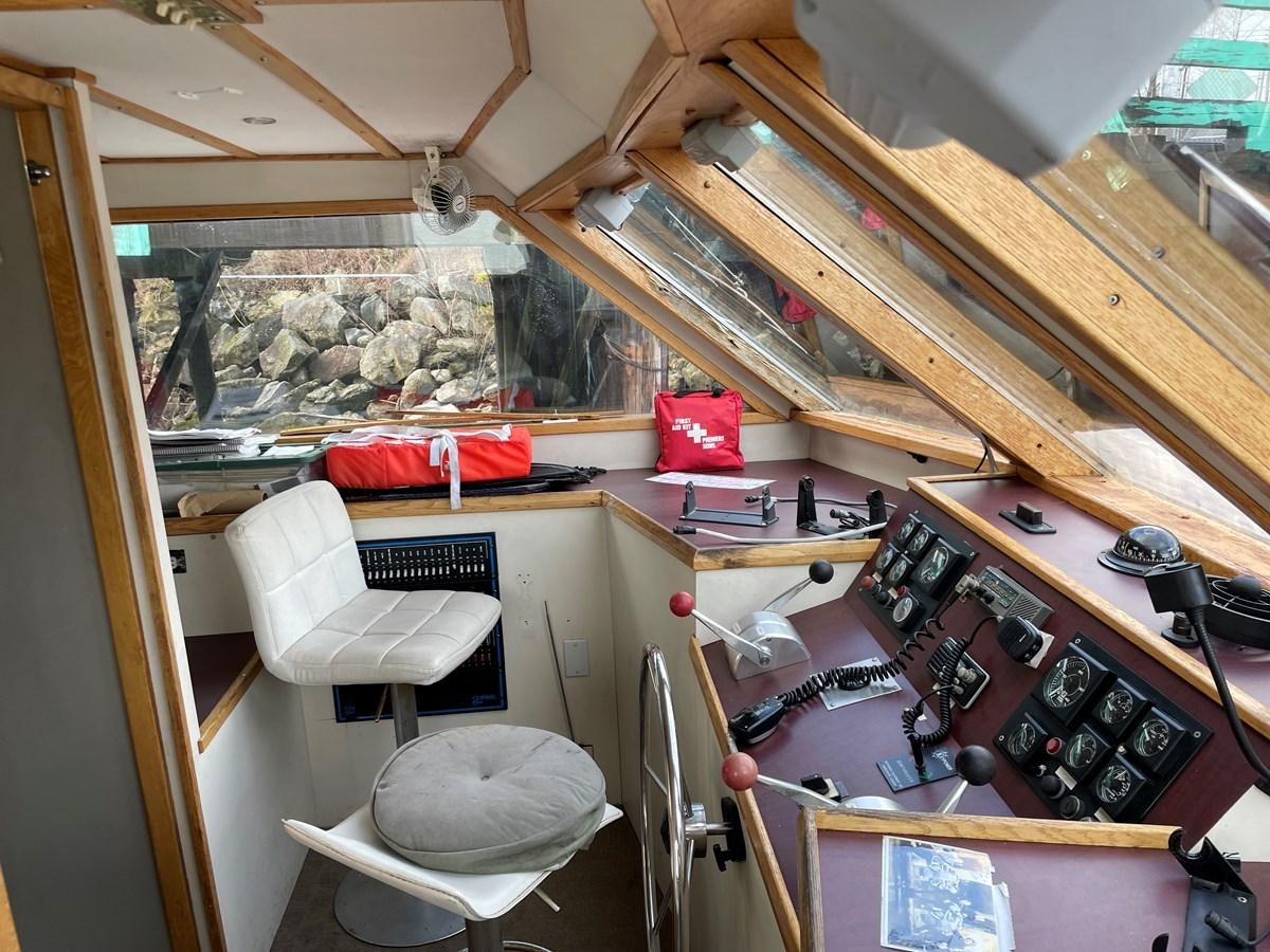 a room with a table and chairs aboard MAGIC MOMENT Yacht for Sale