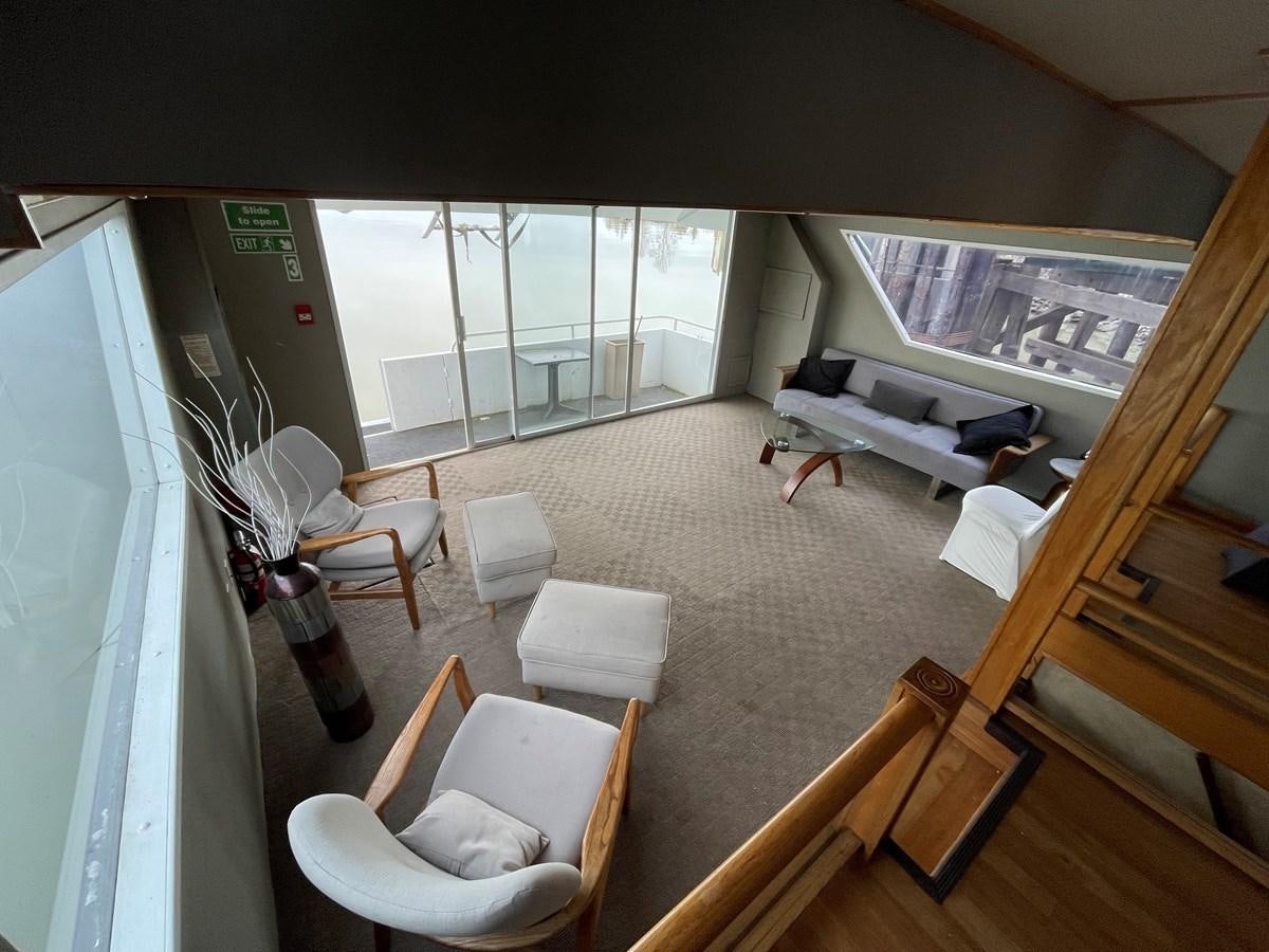 a room with a bed and a table and chairs aboard MAGIC MOMENT Yacht for Sale