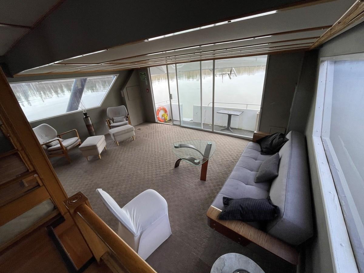 a living room with a couch and a table aboard MAGIC MOMENT Yacht for Sale