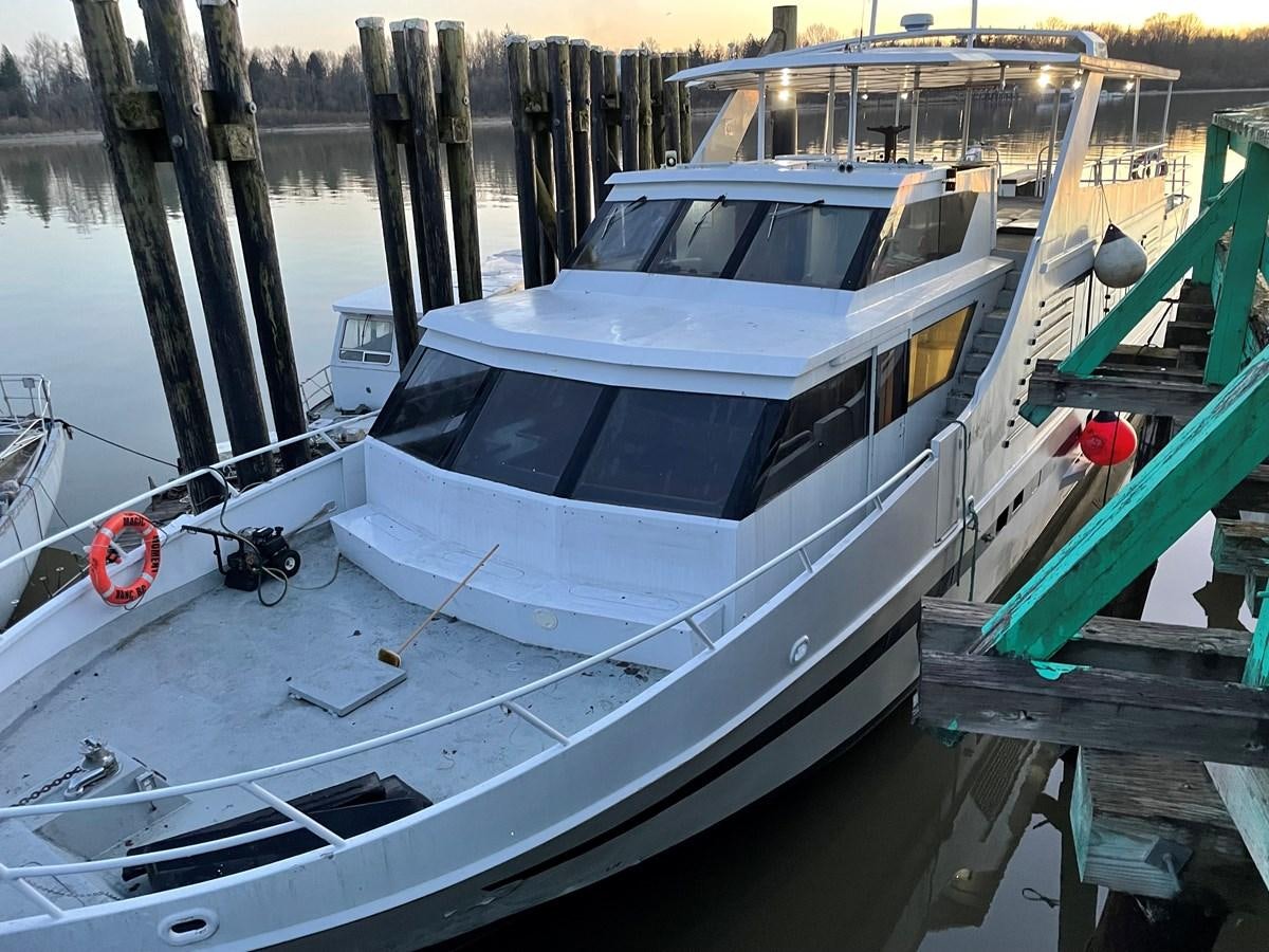 a boat docked in a harbor aboard MAGIC MOMENT Yacht for Sale