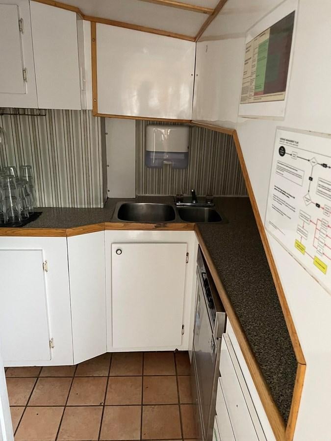 a kitchen with white cabinets aboard MAGIC MOMENT Yacht for Sale