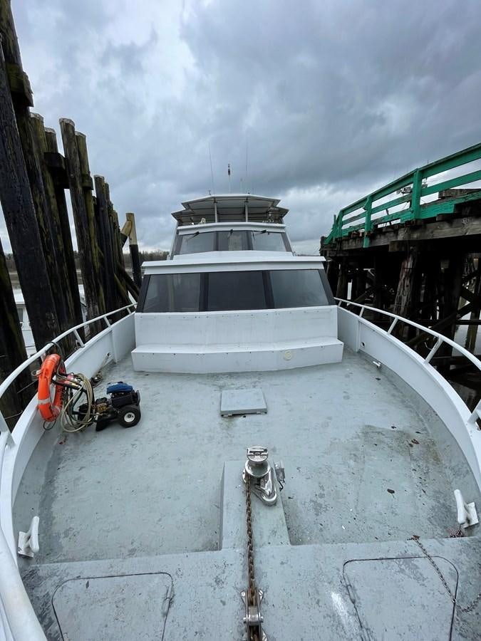 a white boat on a dock aboard MAGIC MOMENT Yacht for Sale