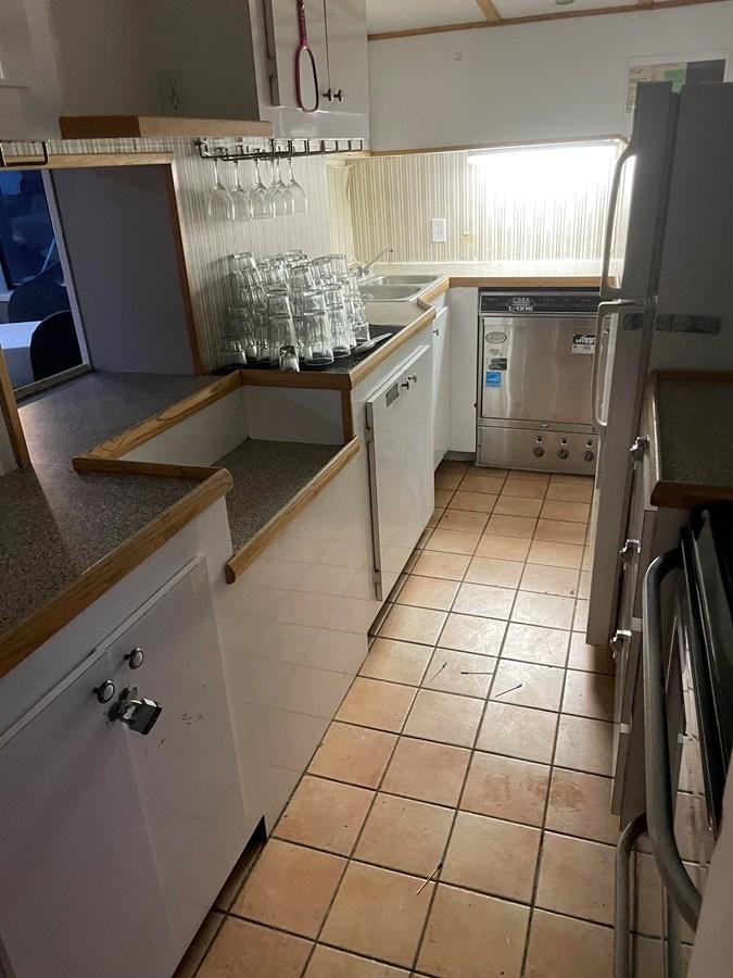 a kitchen with white cabinets aboard MAGIC MOMENT Yacht for Sale