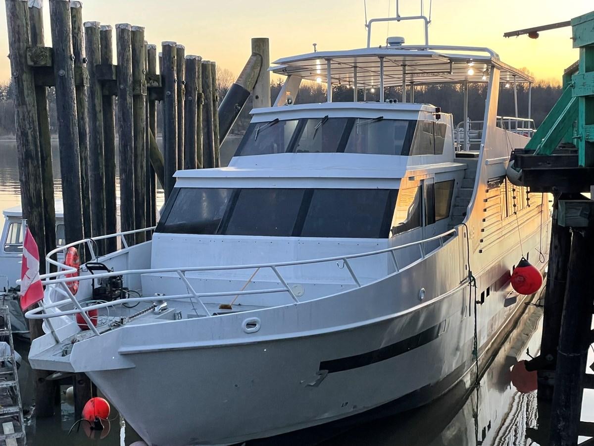 a white boat in a dock aboard MAGIC MOMENT Yacht for Sale