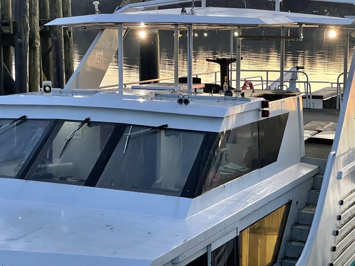 a white boat in a body of water aboard MAGIC MOMENT Yacht for Sale