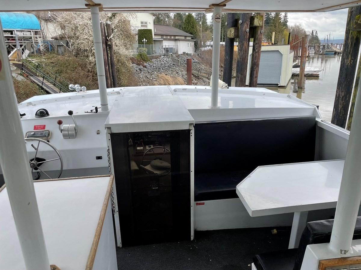 a white table with a black door aboard MAGIC MOMENT Yacht for Sale