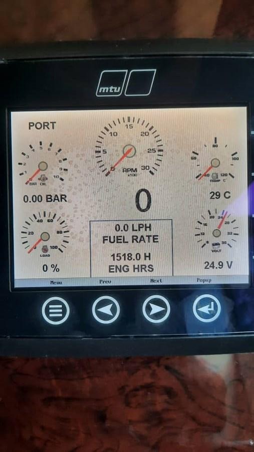 a close up of a digital clock aboard OSCA Yacht for Sale