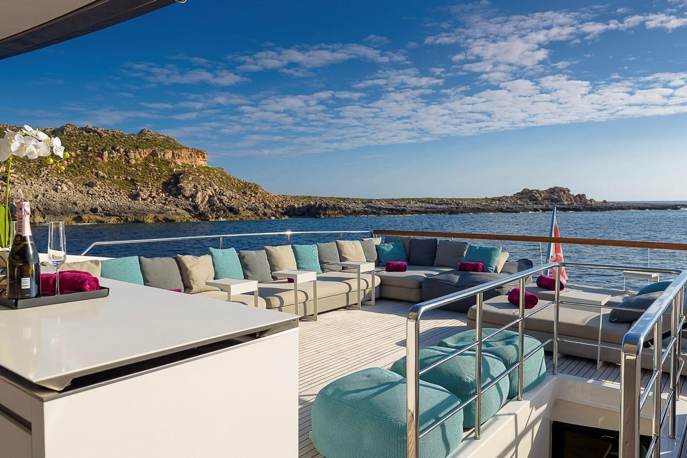a deck with chairs and a pool aboard MUSHA Yacht for Sale
