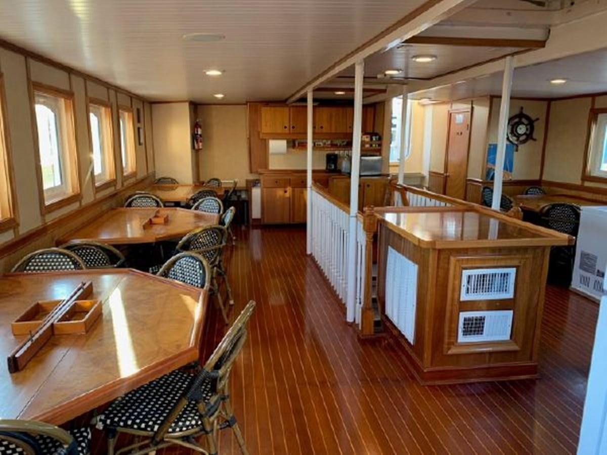 a large kitchen with wooden tables aboard MYSTIC Yacht for Sale