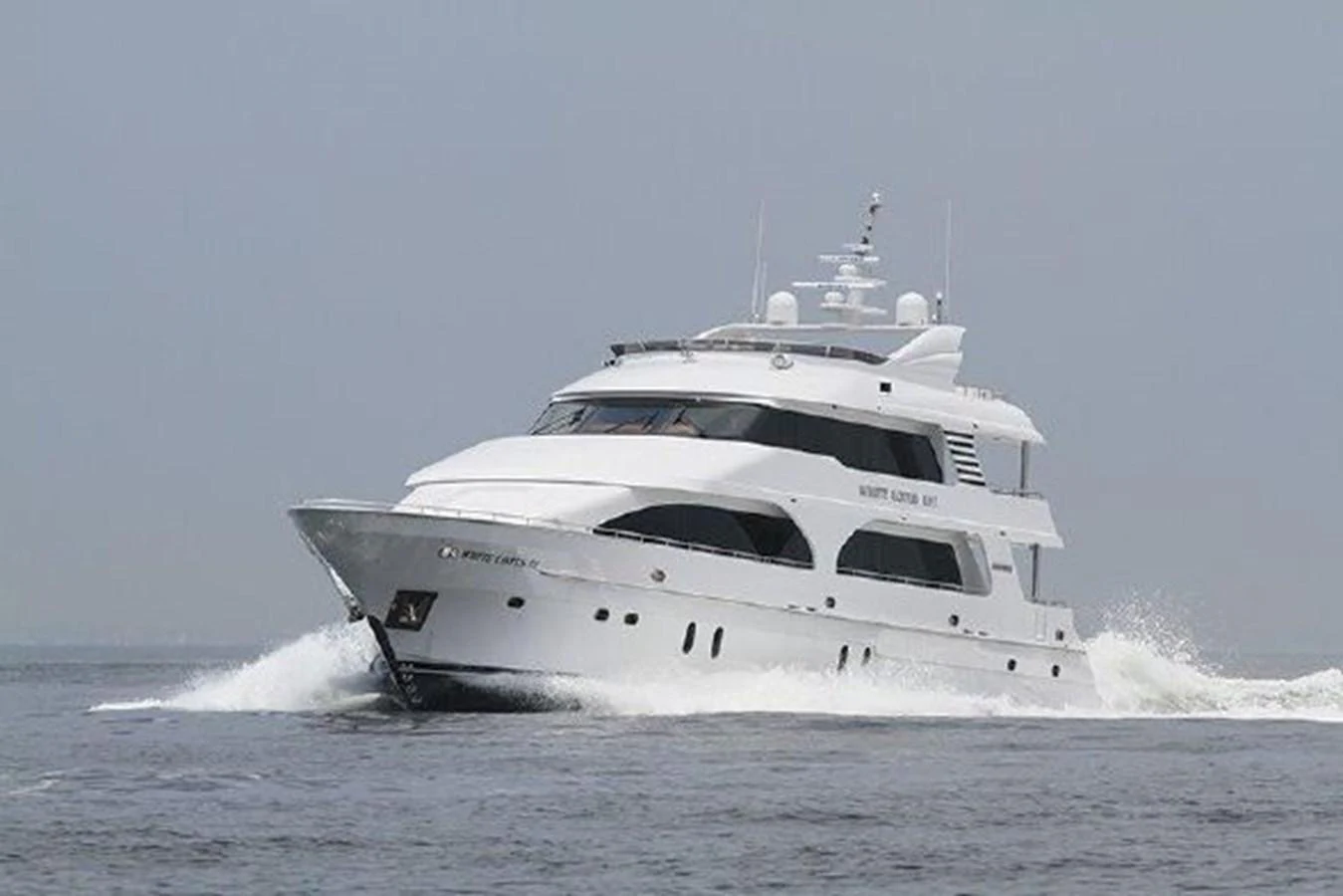 a white yacht on the water aboard WHITE LOTUS Yacht for Sale