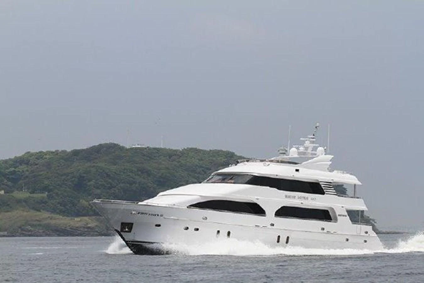 a white yacht on the water aboard WHITE LOTUS Yacht for Sale