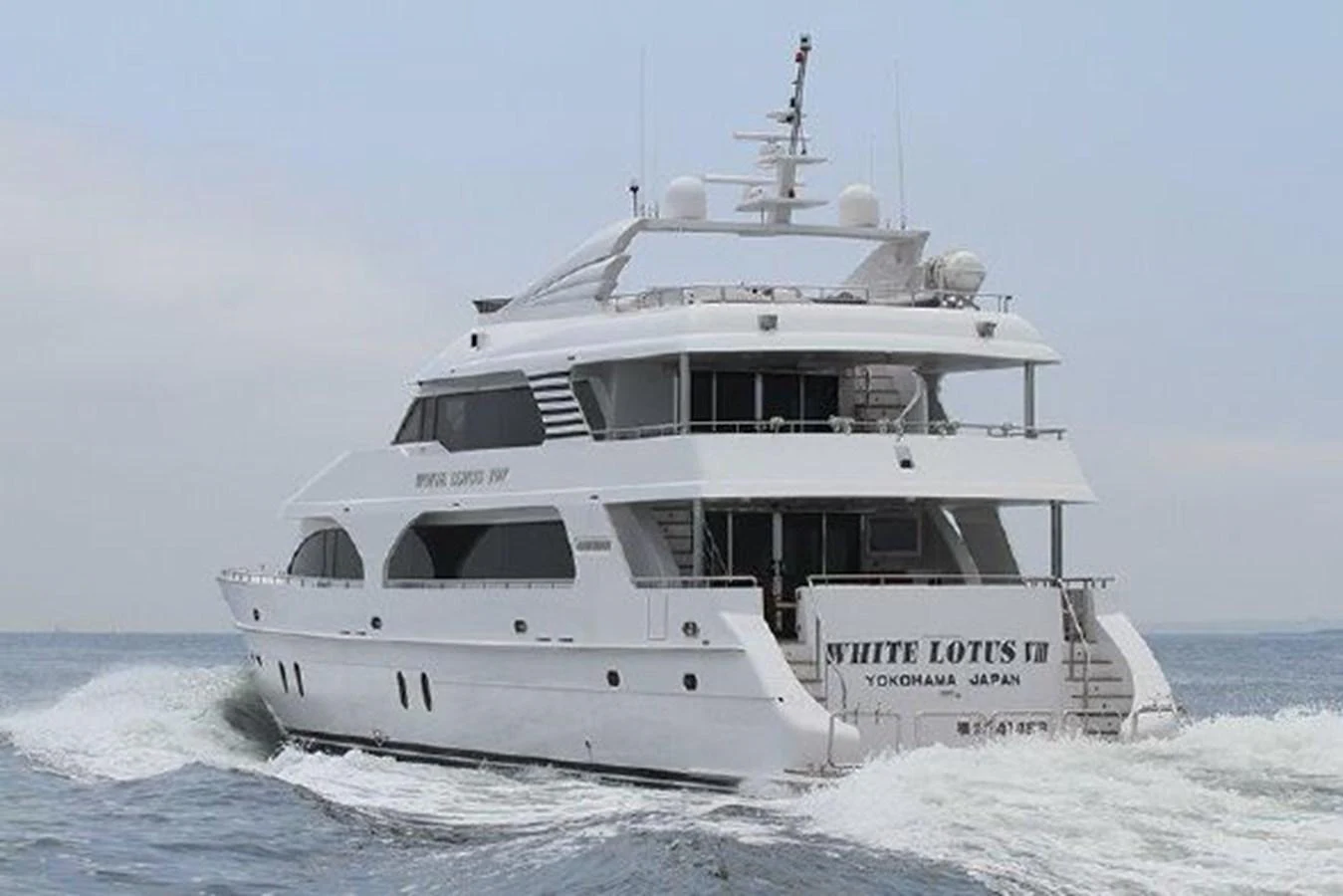 a white boat on the water aboard WHITE LOTUS Yacht for Sale
