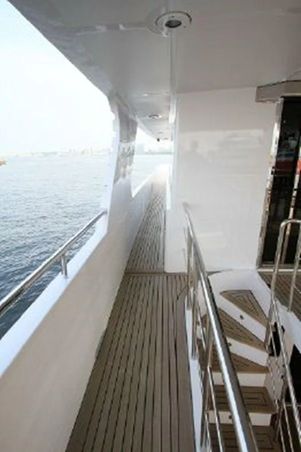 a long white boat on a body of water aboard WHITE LOTUS Yacht for Sale