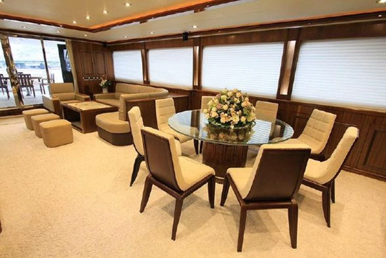 a room with a table chairs and a couch aboard WHITE LOTUS Yacht for Sale