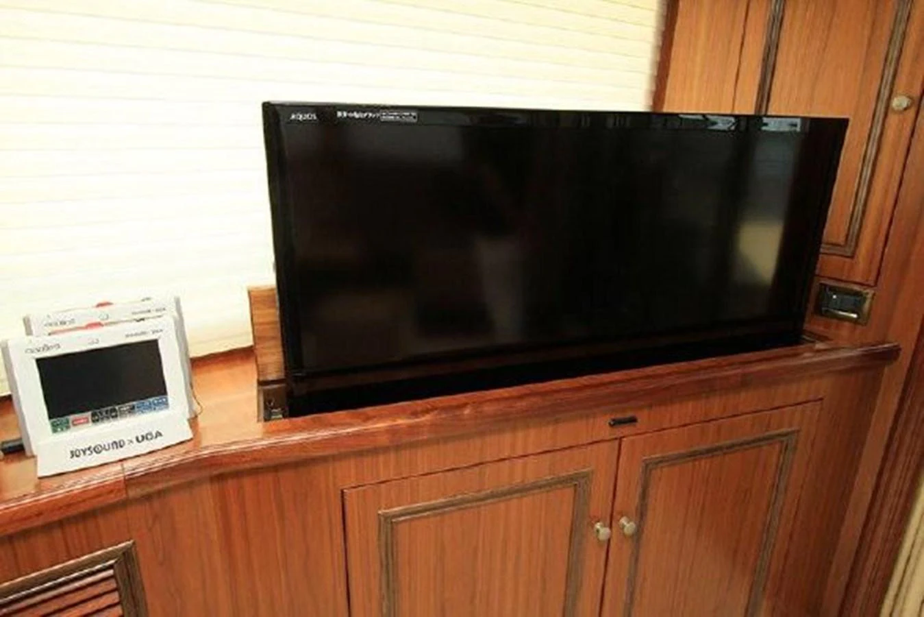 a tv on a cabinet aboard WHITE LOTUS Yacht for Sale