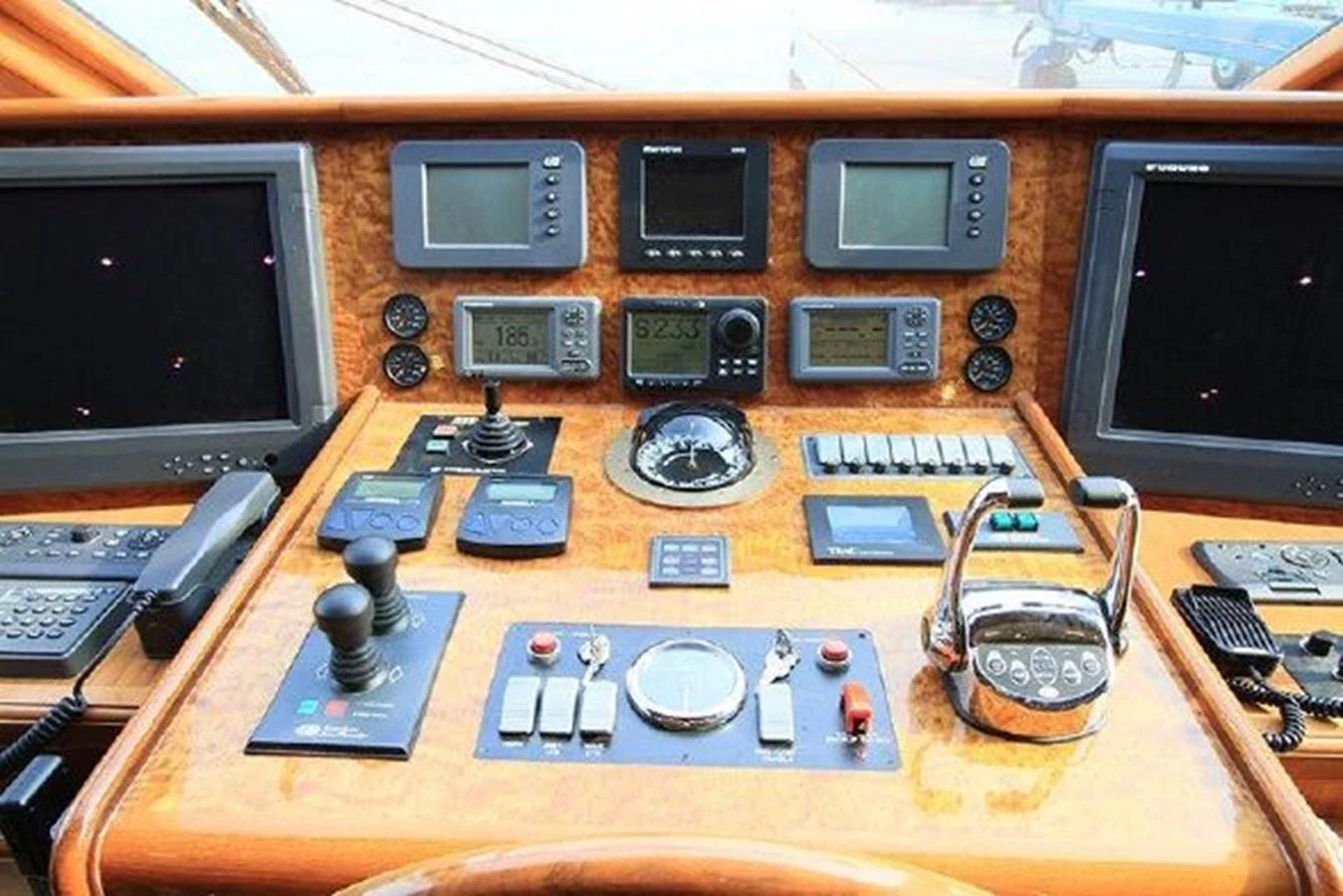 a wooden panel with electronic equipment aboard WHITE LOTUS Yacht for Sale