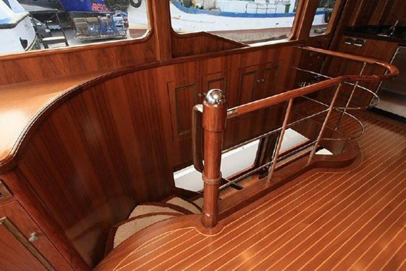 a wooden chair with a metal frame aboard WHITE LOTUS Yacht for Sale