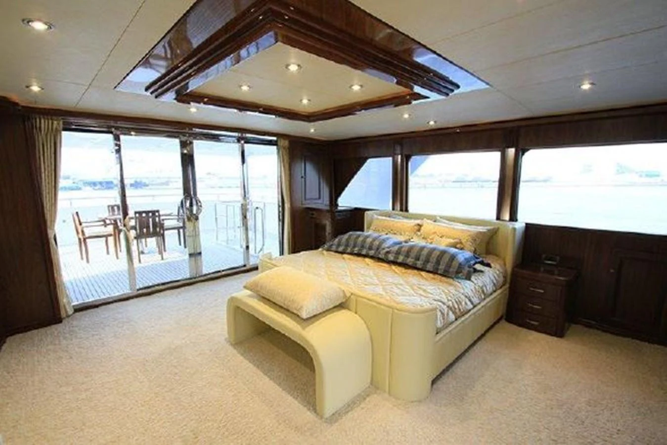 a large bedroom with a large glass door aboard WHITE LOTUS Yacht for Sale