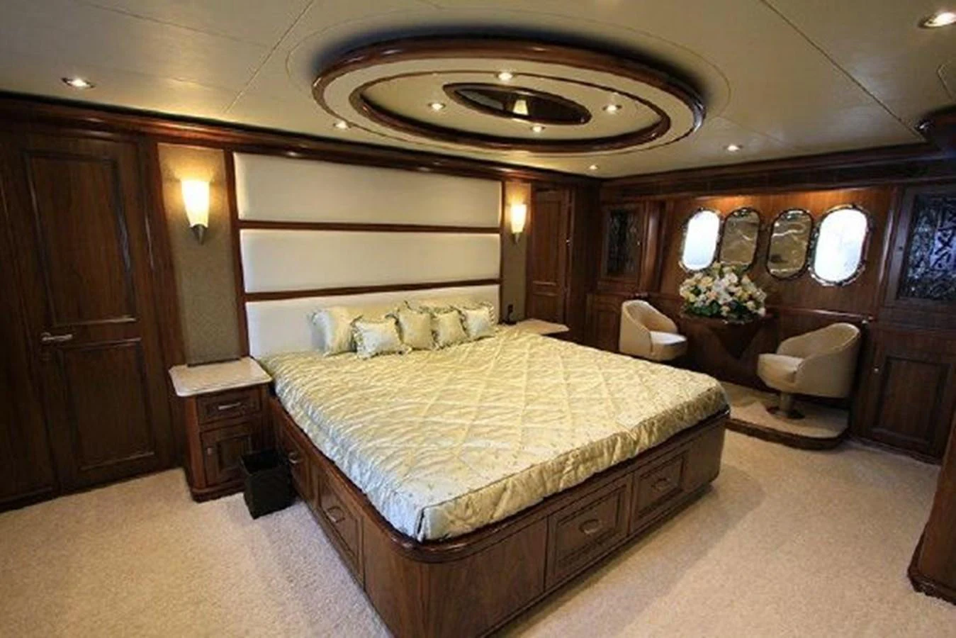 a bedroom with a bed and a desk aboard WHITE LOTUS Yacht for Sale