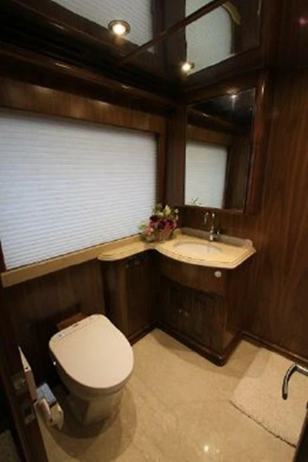 a bathroom with a toilet and a sink aboard WHITE LOTUS Yacht for Sale
